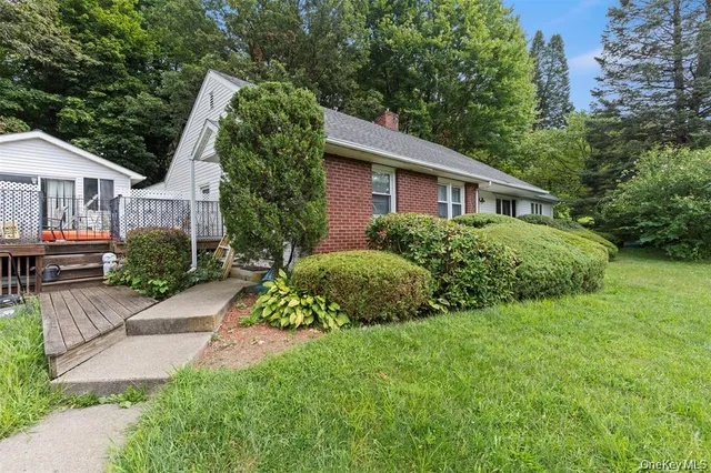 a front view of a house with a garden