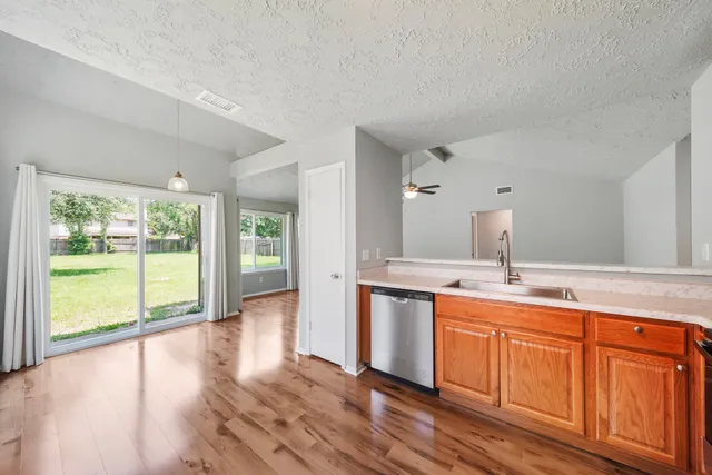 a kitchen with a sink and wooden cabinets