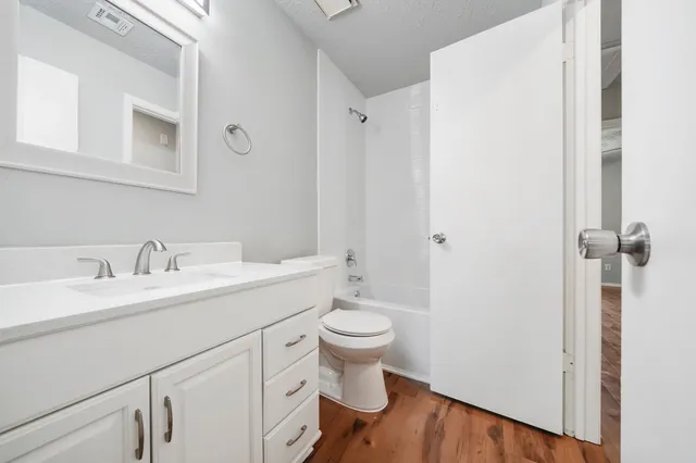 a bathroom with a sink toilet and a mirror