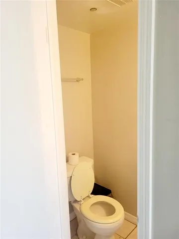 a white toilet sitting next to a white sink
