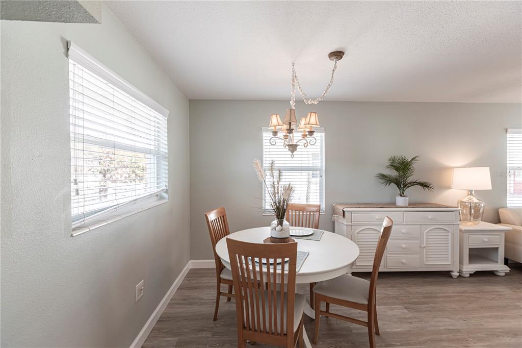 6020 Midnight Pass Road, Unit 10 Sarasota, FL 34242 - Photo 11 of 21 a view of a dining room with furniture window and wooden floor