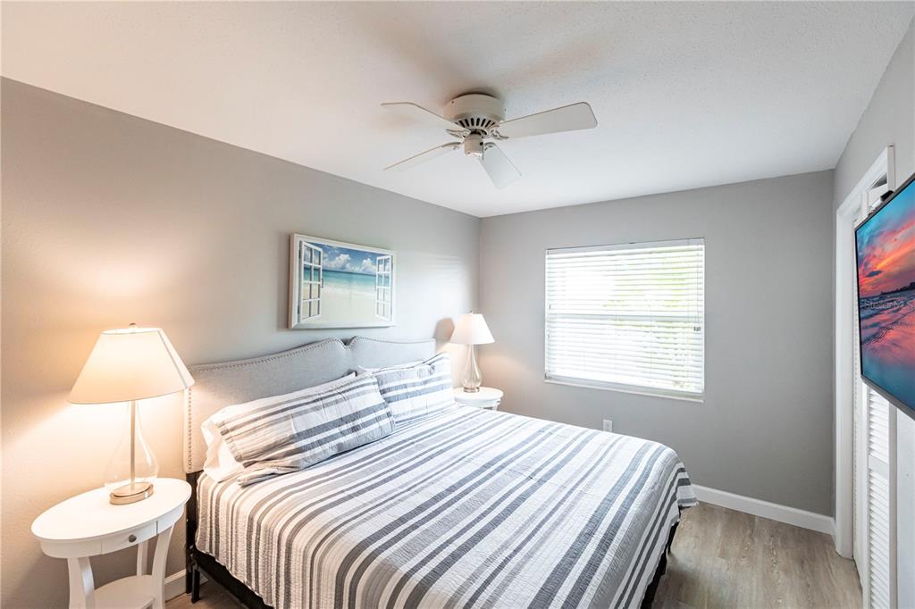 6020 Midnight Pass Road, Unit 10 Sarasota, FL 34242 - Photo 13 of 21 a bedroom with a bed and a window