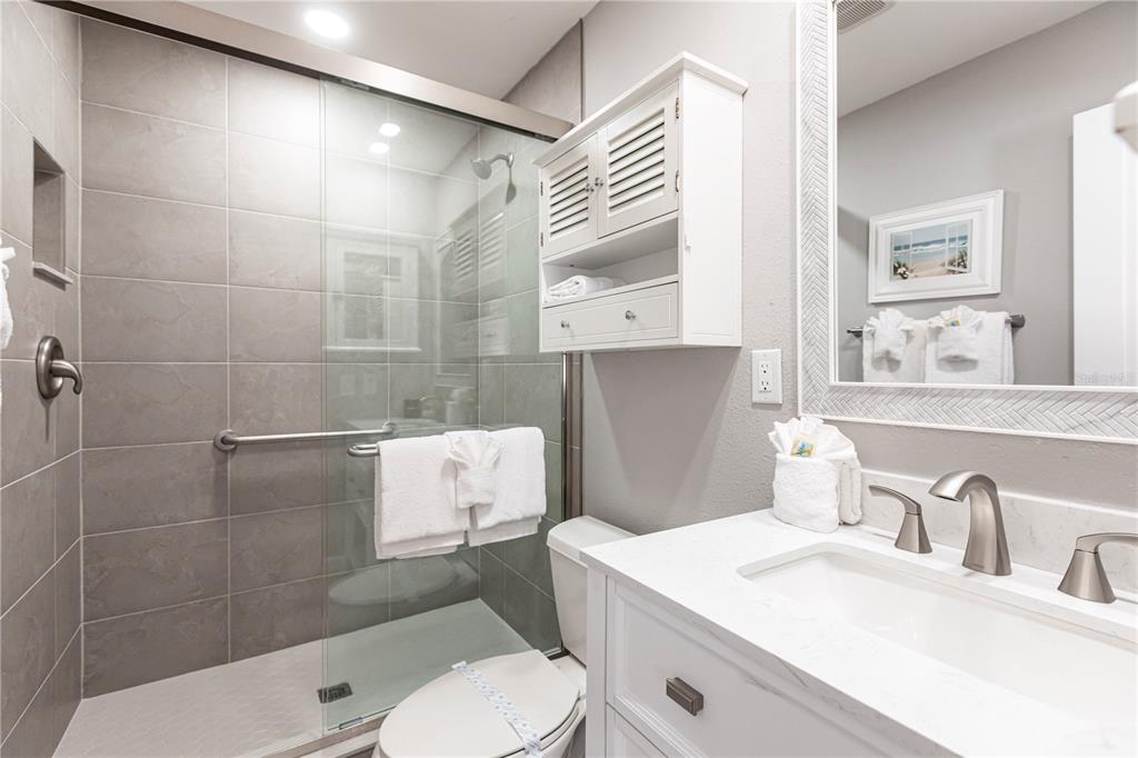 6020 Midnight Pass Road, Unit 10 Sarasota, FL 34242 - Photo 17 of 21 a bathroom with a sink toilet and shower