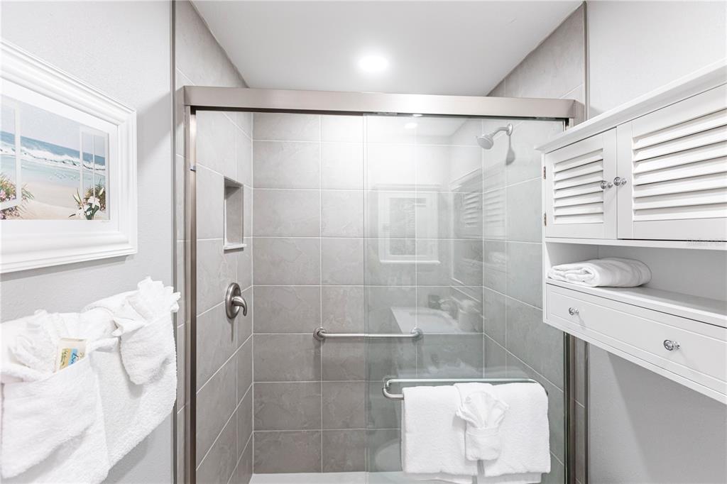 6020 Midnight Pass Road, Unit 10 Sarasota, FL 34242 - Photo 18 of 21 a bathroom with a shower and a sink