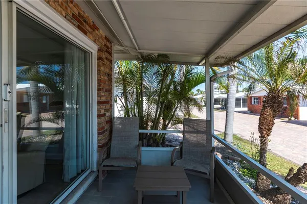 a backyard of a house with table and chairs