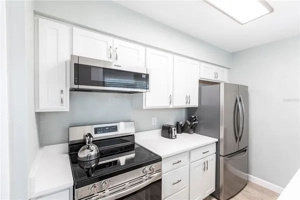 a kitchen with stainless steel appliances a stove a microwave and a refrigerator