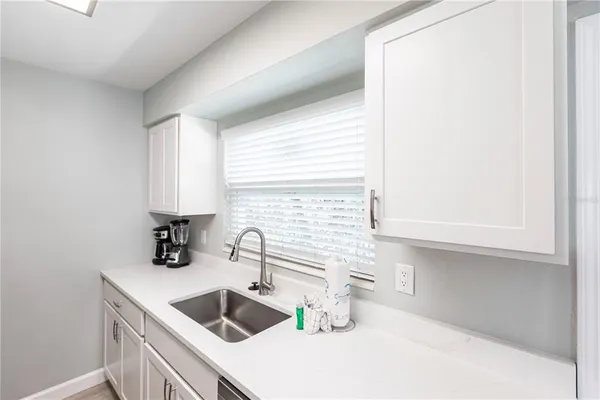 a kitchen with a sink and a refrigerator
