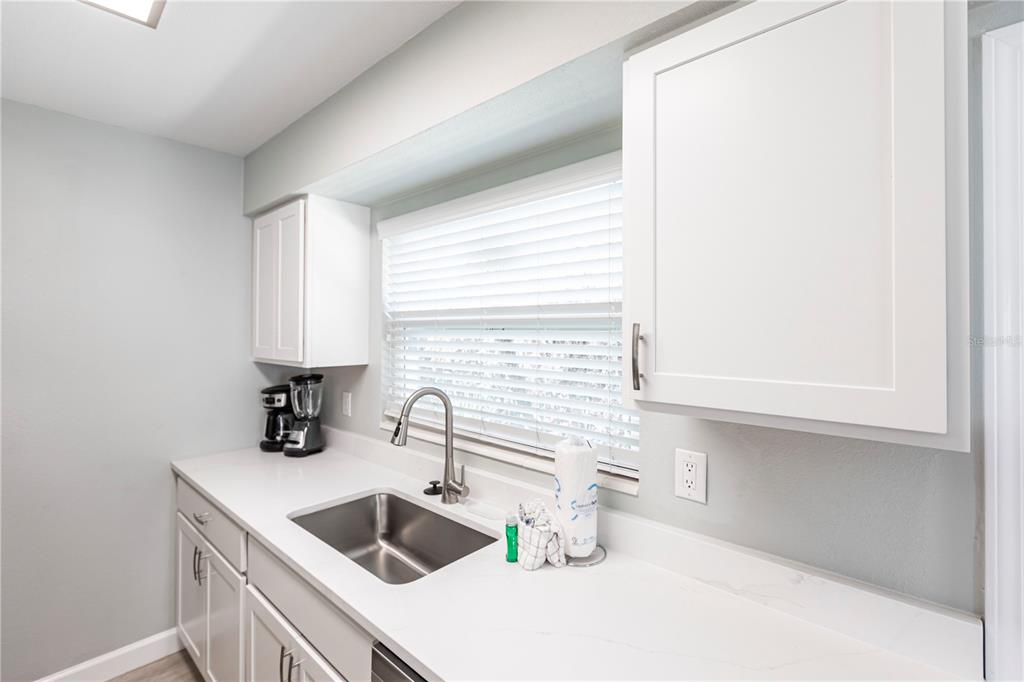 6020 Midnight Pass Road, Unit 10 Sarasota, FL 34242 - Photo 9 of 21 a kitchen with a sink and a refrigerator