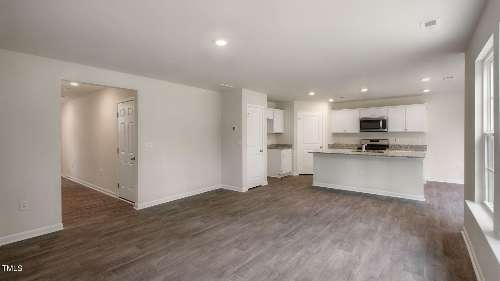 613 Stream Walk Crossing Wendell, NC 27591 - Photo 5 of 32 a view of kitchen view with wooden floor and stainless steel appliances