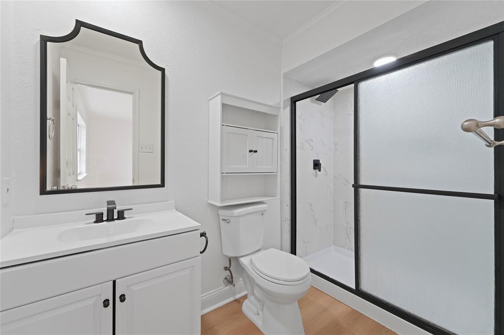 5516 Maple Lane Rowlett, TX 75089 - Photo 13 of 18 a bathroom with a sink toilet and shower a mirror