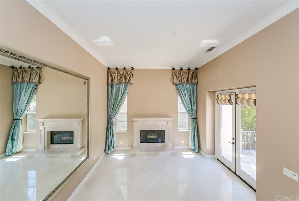 31 Climbing Vine Irvine, CA 92603 - Photo 4 of 20 a view of an empty room with a fireplace and a window