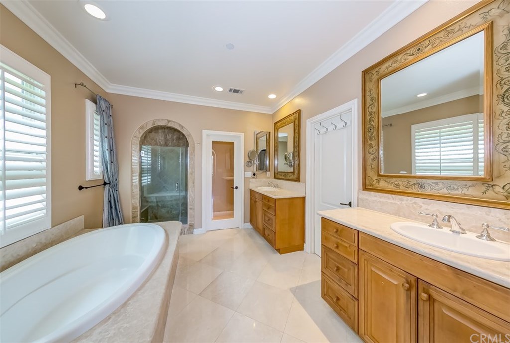 31 Climbing Vine Irvine, CA 92603 - Photo 10 of 20 a spacious bathroom with a tub sink shower and mirror