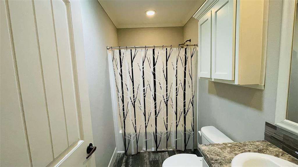 8394 Lake Road Mansfield, TX 76063 - Photo 17 of 22 a bathroom with a toilet and a mirror