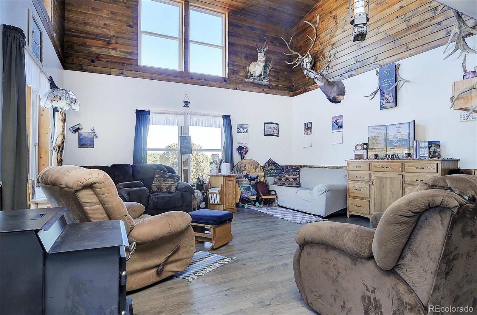 1700 Mitchell Mountain Road Westcliffe, CO 81252 - Photo 5 of 40 a living room with furniture kitchen view and a large window