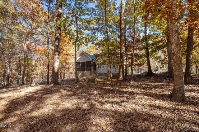 a front view of a house with a tree