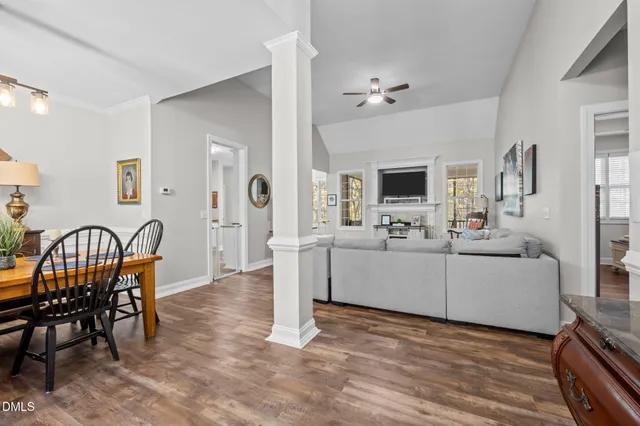a living room with furniture a dining table and a fireplace