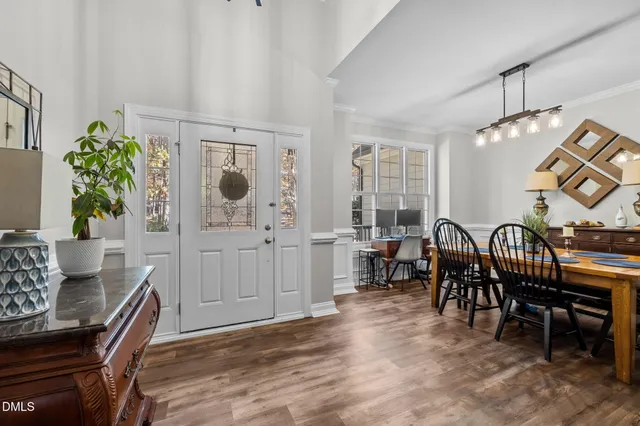 a living room with furniture a chandelier a rug and a window