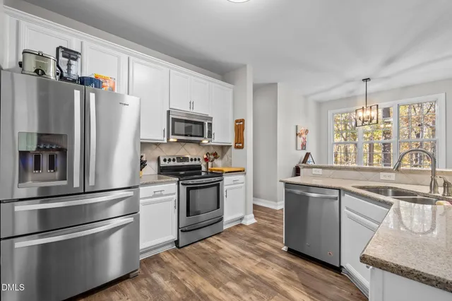 a kitchen with granite countertop stainless steel appliances and wooden cabinets