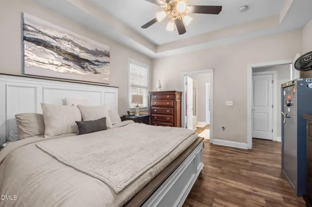 a bedroom with a large bed and a chandelier