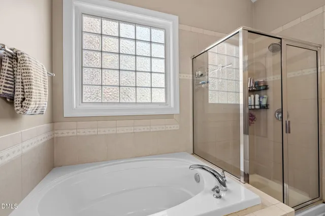 a bathroom with a bathtub and a shower