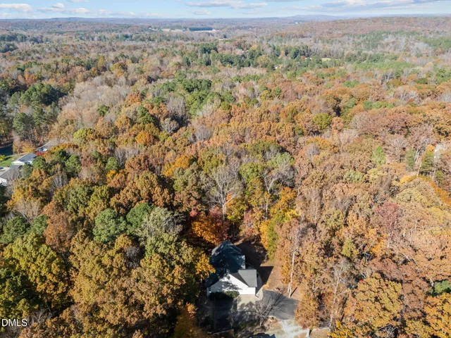 a view of a field with trees in the background
