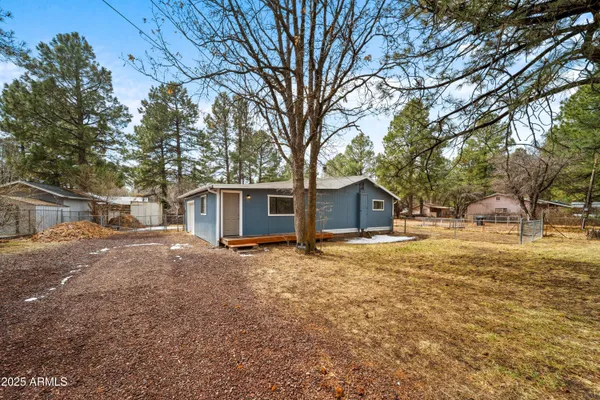 a tree is standing in front of a house