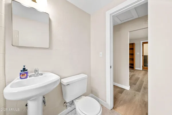 a white toilet sitting next to a bathroom sink