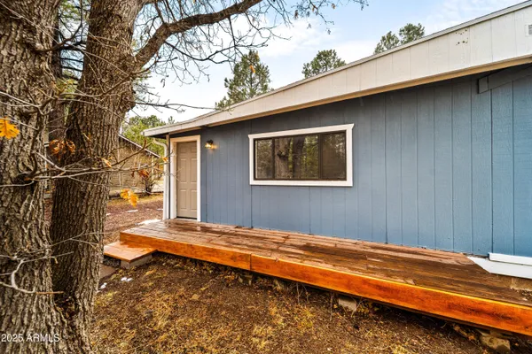 a view of a house with a wooden fence