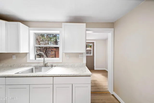 a kitchen with a sink cabinets and window