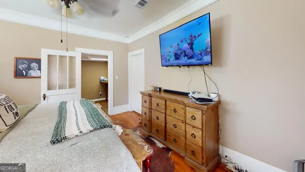 a bedroom with a bed and a chandelier