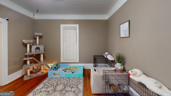 a living room with furniture and a book shelf