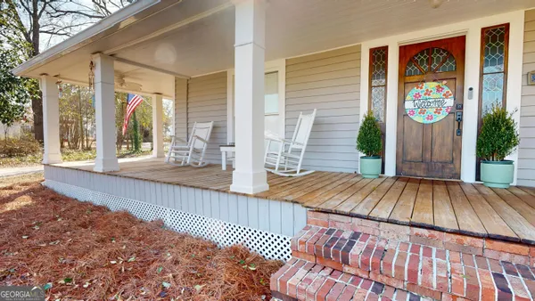 a view of a porch with wooden floor and floor to ceiling window