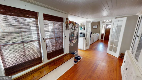 a hallway with furniture and wooden floor