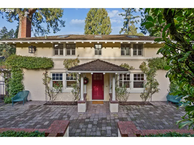a view of a large building with a lot of windows and plants