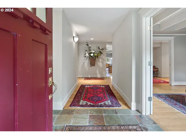 a living room with furniture a fireplace and a floor to ceiling window