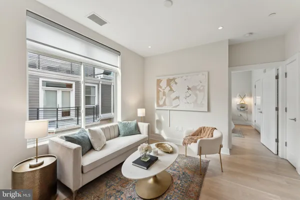 a living room with furniture and a large window