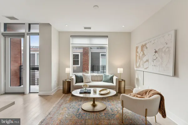 a living room with furniture a window and a potted plant