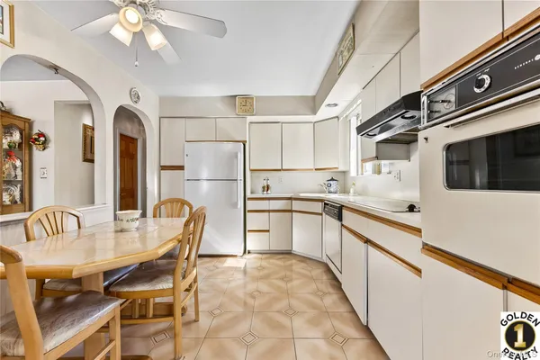 a kitchen with refrigerator cabinets and dining table