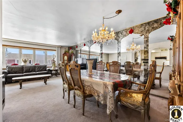 a view of a dining room with furniture and chandelier