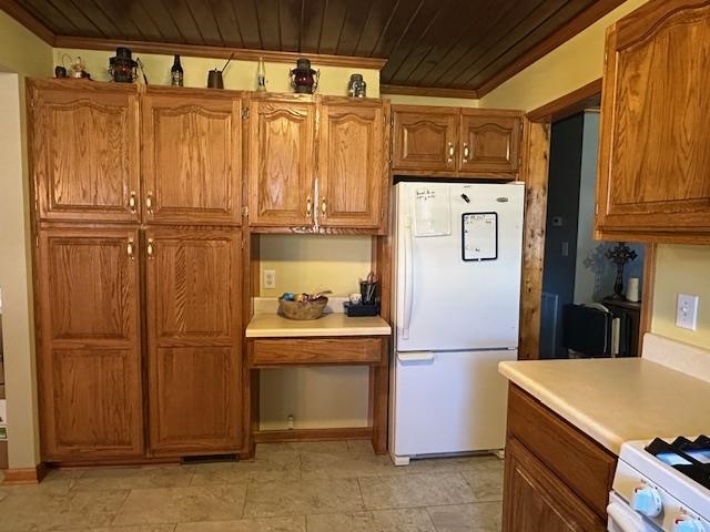 1555 Rich Road Savannah, TN 38372 - Photo 3 of 18 Kitchen with white appliances, light countertops, wooden ceiling, and brown cabinets