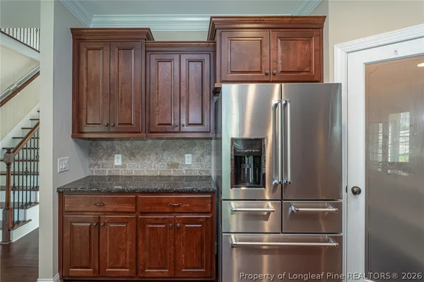a kitchen with stainless steel appliances granite countertop a refrigerator and cabinets