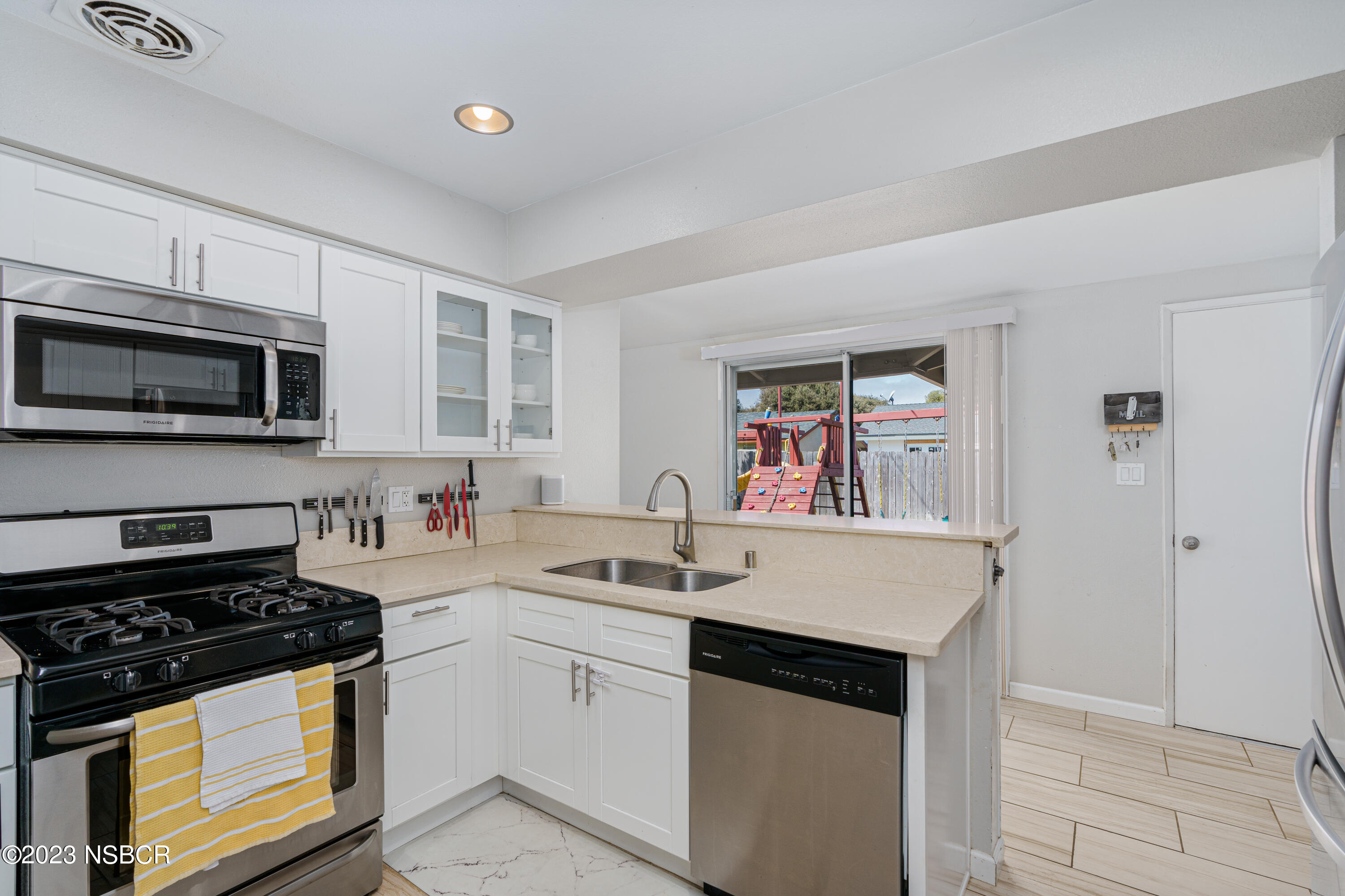509 North Poppy Street Lompoc, CA 93436 - Photo 11 of 36 a kitchen with a sink stove top oven and cabinets