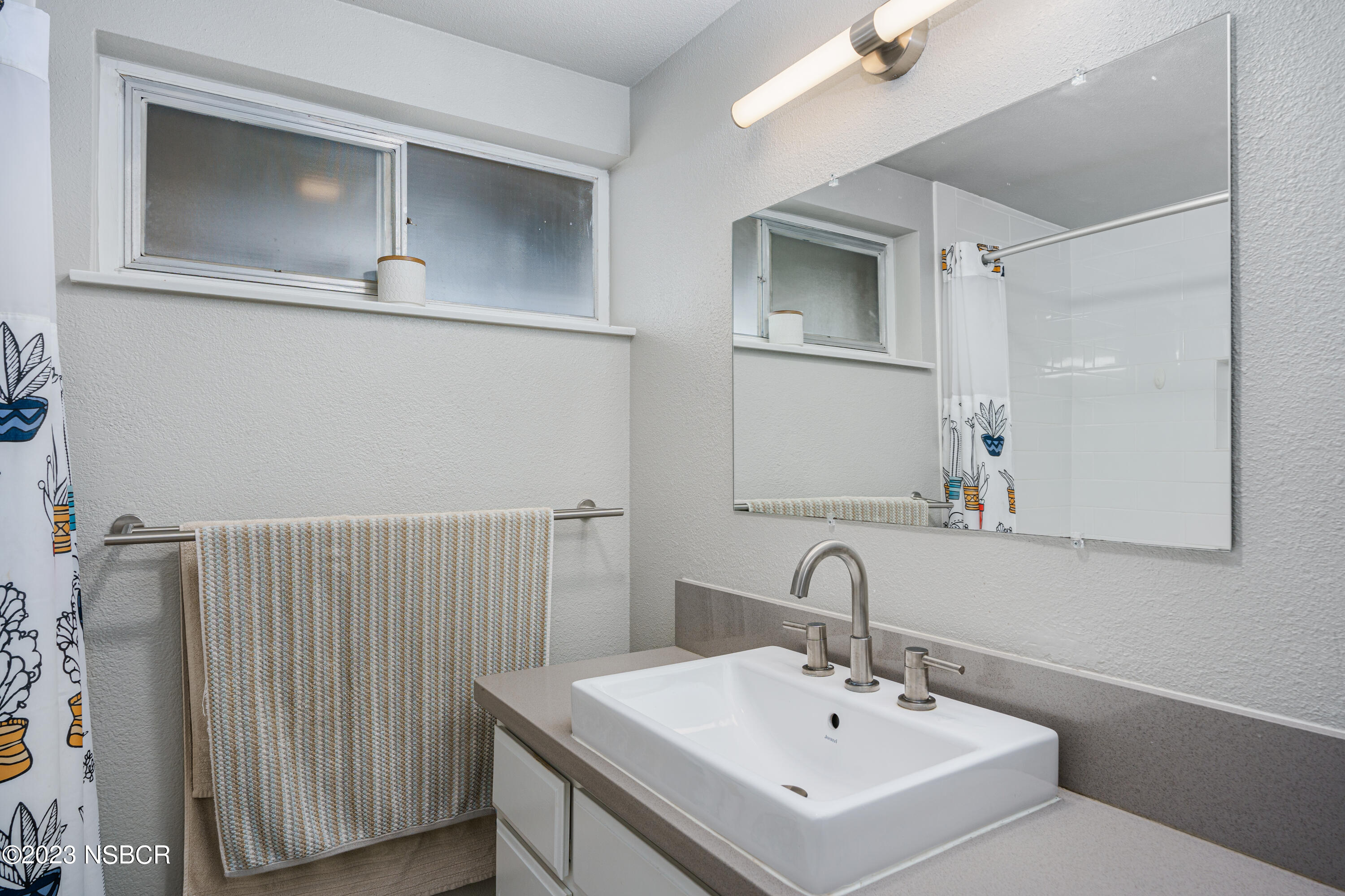 509 North Poppy Street Lompoc, CA 93436 - Photo 17 of 36 a bathroom with a sink and a mirror