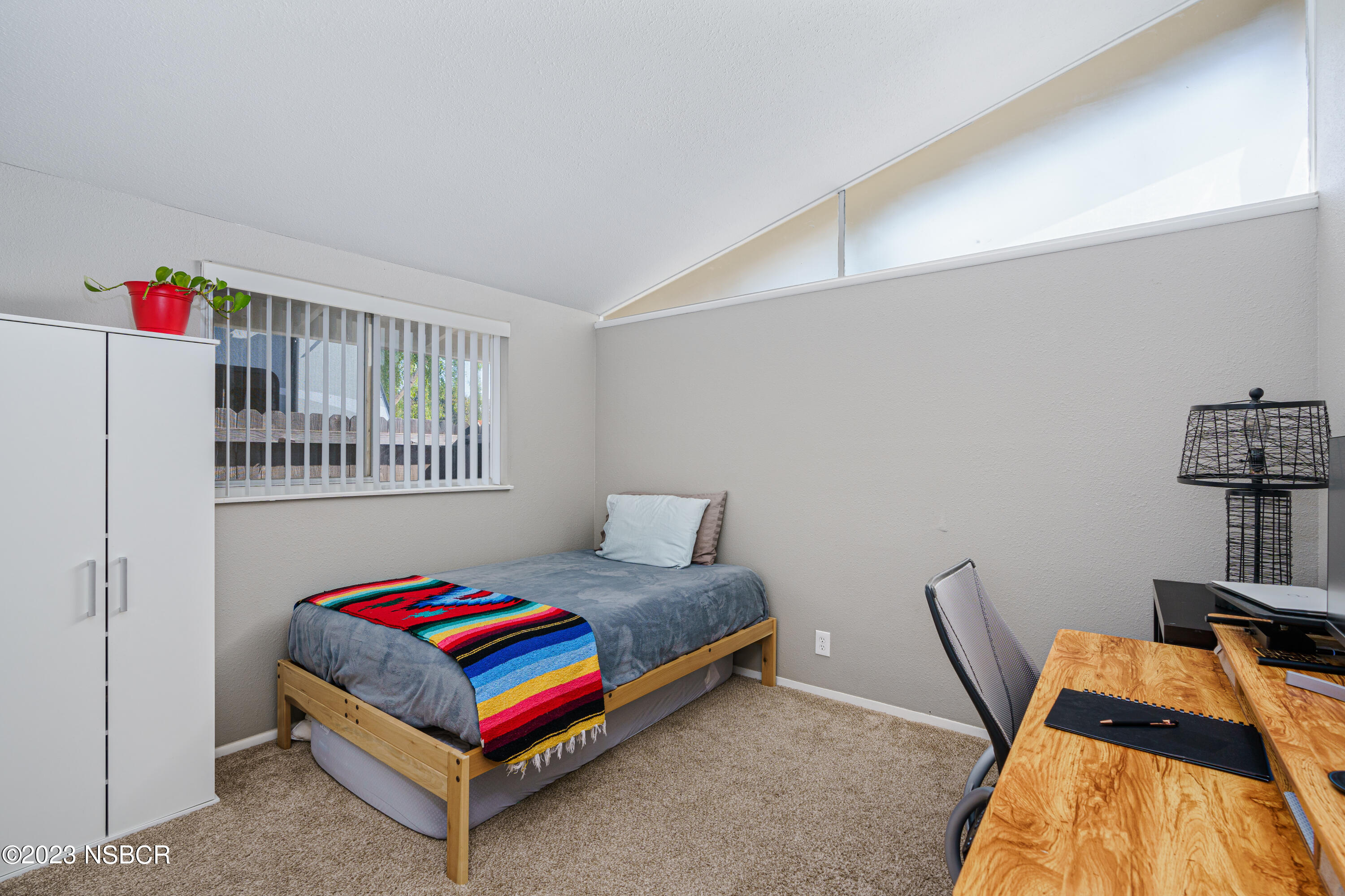 509 North Poppy Street Lompoc, CA 93436 - Photo 18 of 36 a bedroom with furniture and a book shelf