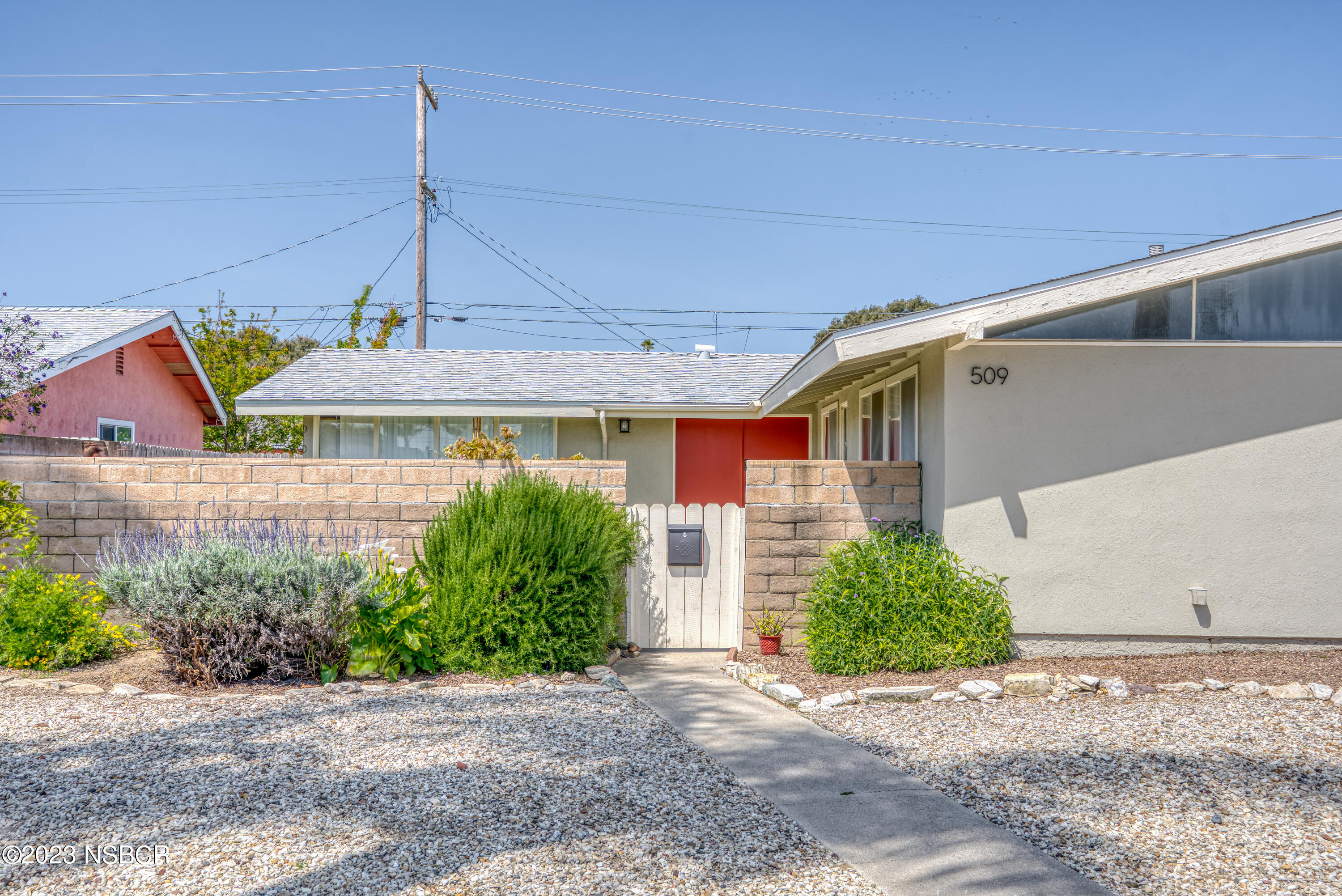 509 North Poppy Street Lompoc, CA 93436 - Photo 2 of 36 a front view of a house with garden