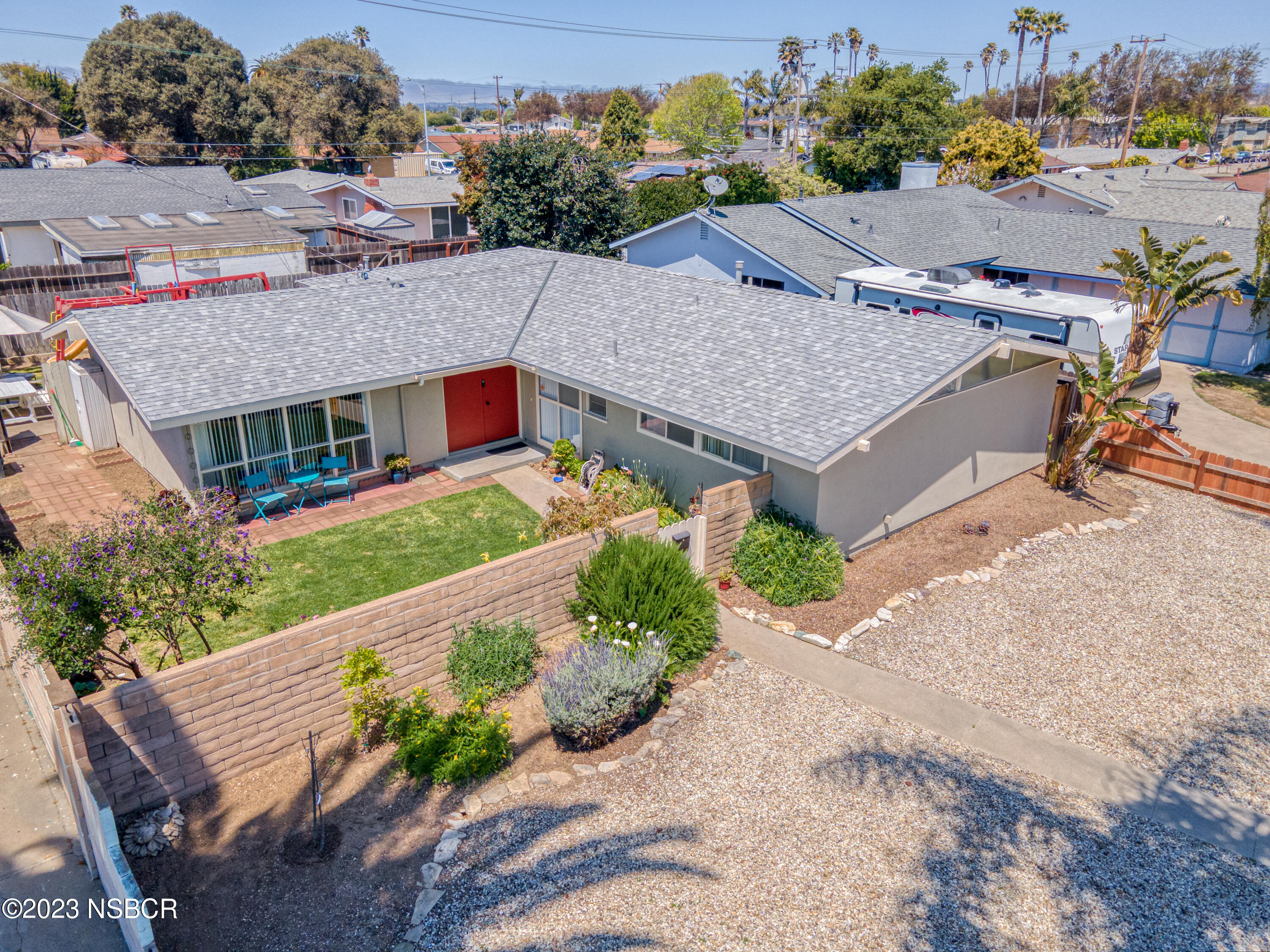 509 North Poppy Street Lompoc, CA 93436 - Photo 27 of 36 an aerial view of a house with a yard and potted plants