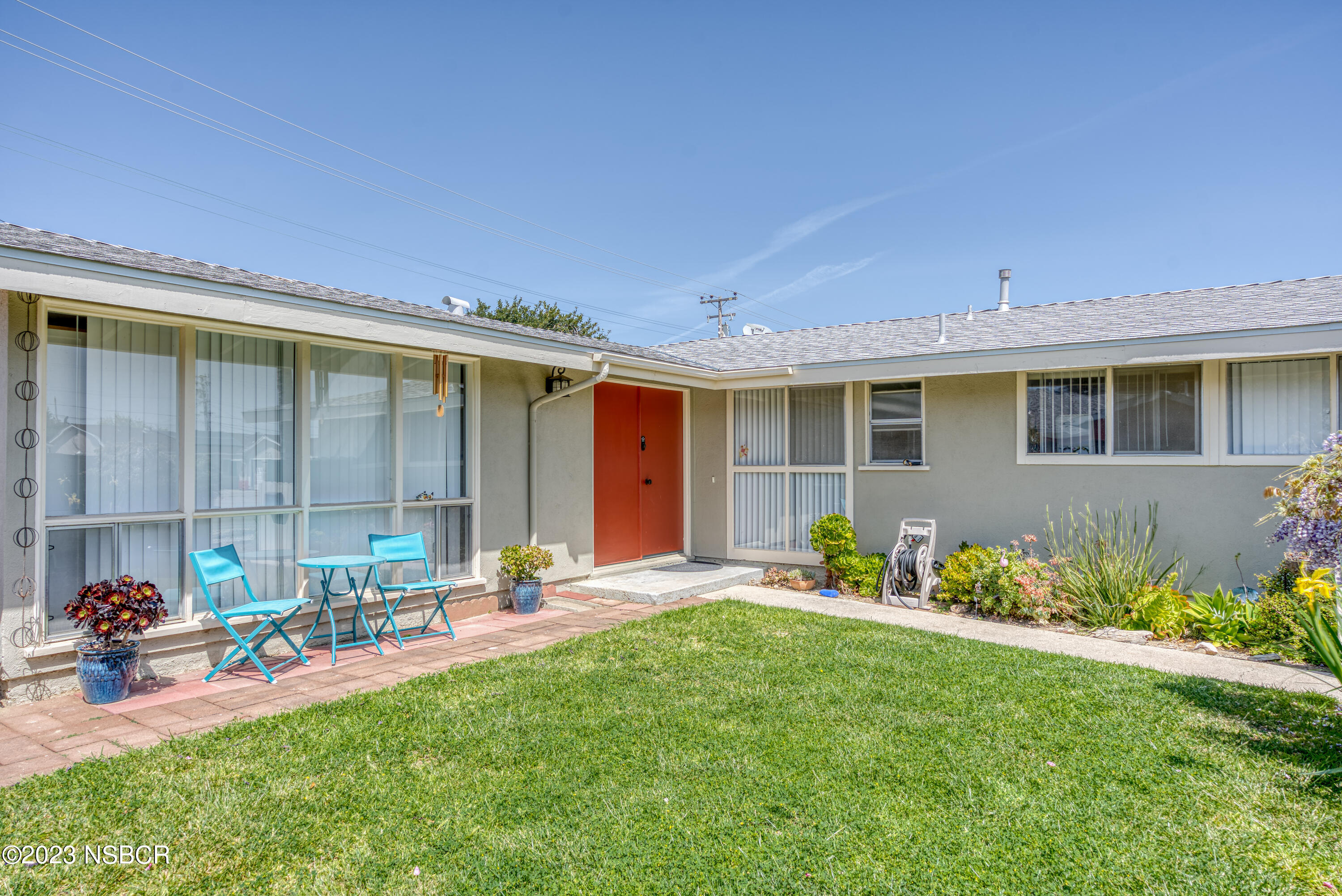 509 North Poppy Street Lompoc, CA 93436 - Photo 5 of 36 a front view of a house with a garden and patio