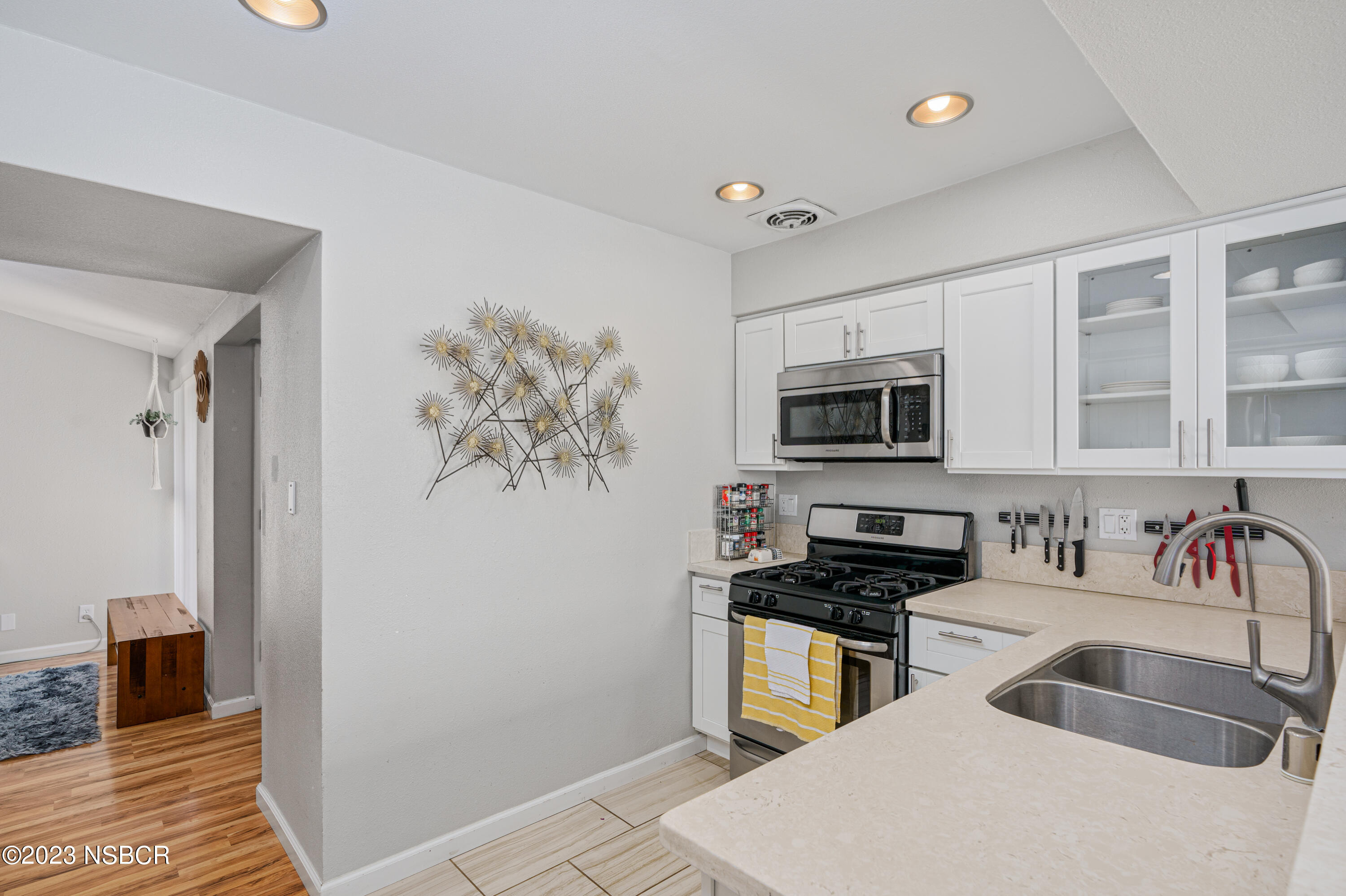 509 North Poppy Street Lompoc, CA 93436 - Photo 10 of 36 a kitchen with stainless steel appliances a sink a microwave a refrigerator and cabinets