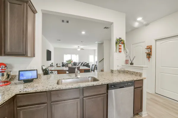 a kitchen with granite countertop kitchen island a sink appliances and cabinets