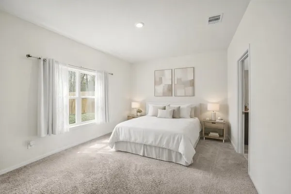 a bedroom with a bed and a window